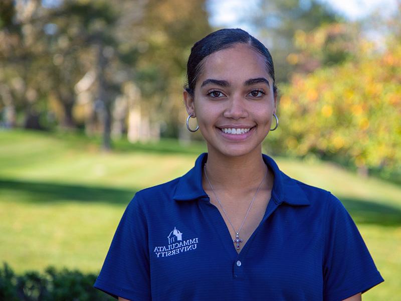 Young woman in polo shirt outside